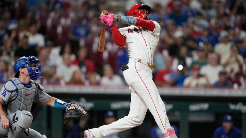 Cincinnati Reds shortstop Elly De La Cruz, right, watches his solo home run as Los Angeles...