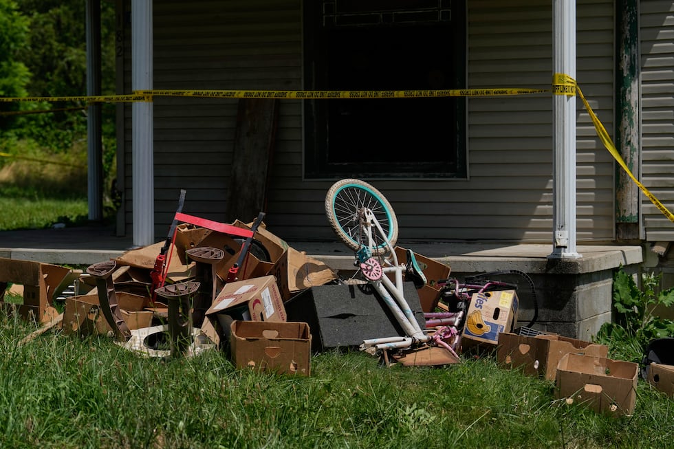 Police tape and debris are seen at a home where authorities say they removed 16 children and...